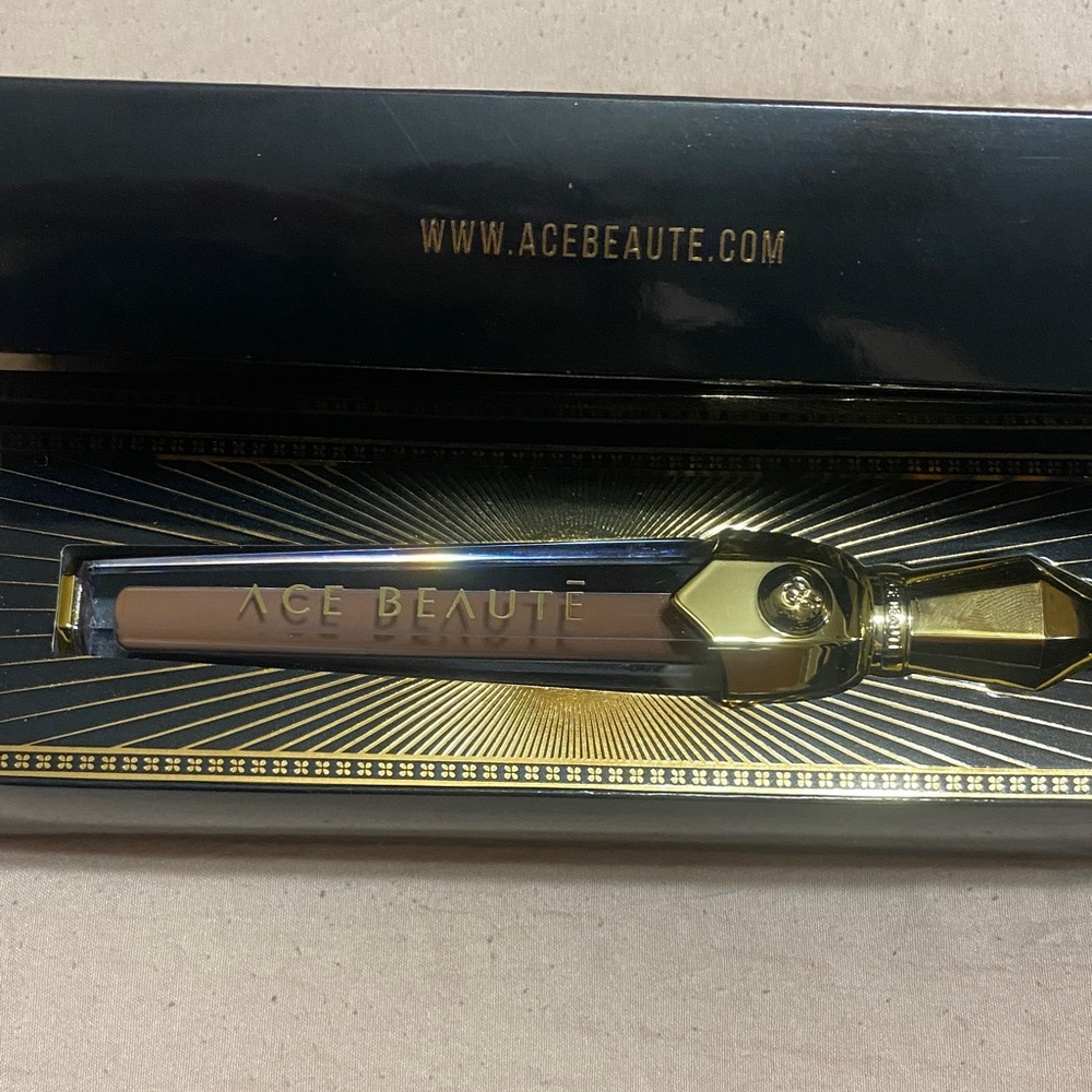 Ace Beauté Pout Perfect liquid lipstick in Manifest. Gold and clear amulet shape